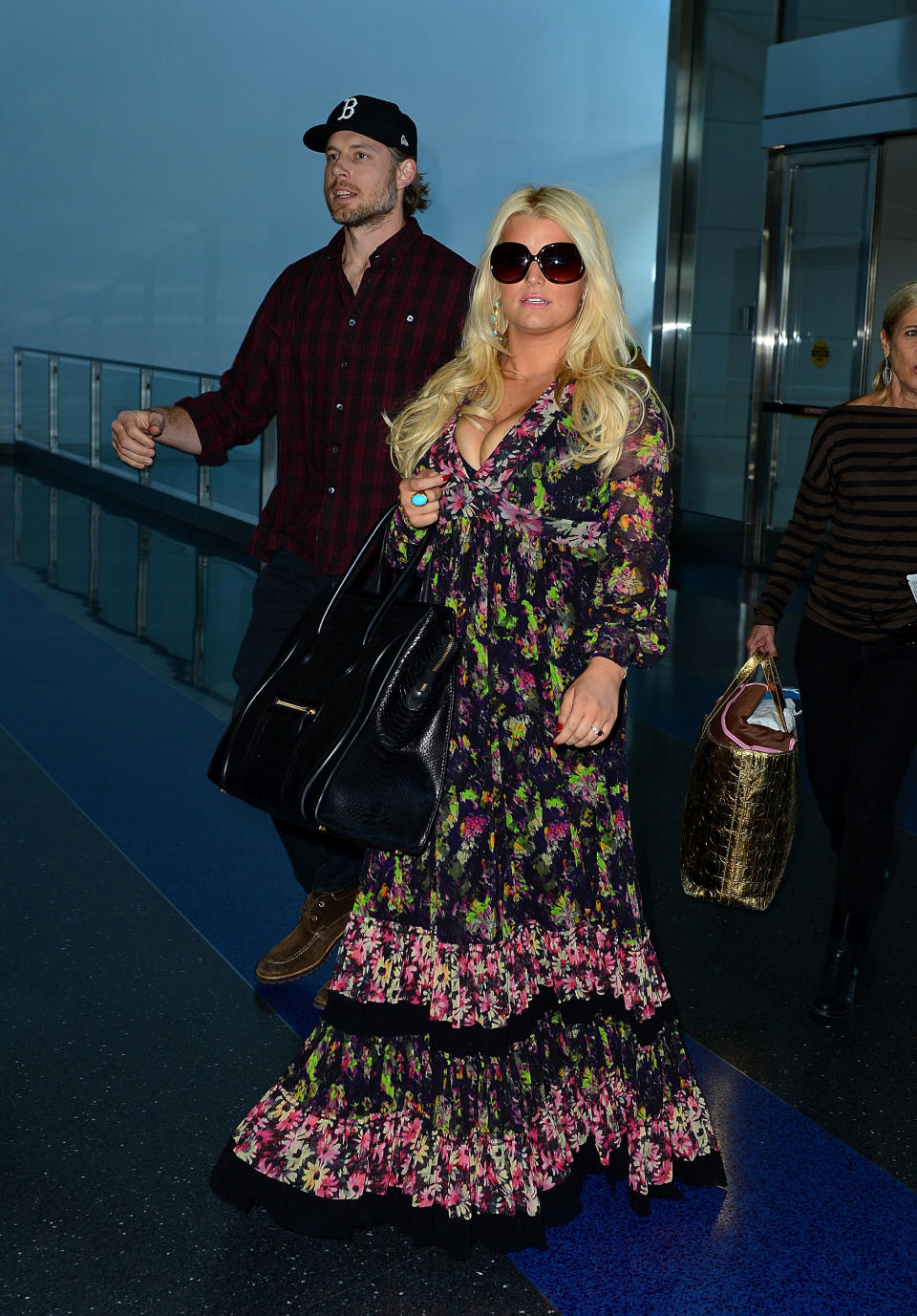 <div class="caption-credit"> Photo by: Getty Images</div>Tray table is certainly in its upright position! Jessica Simpson's modest look at JFK in September 2012 is offset by her aggressive cleavage.