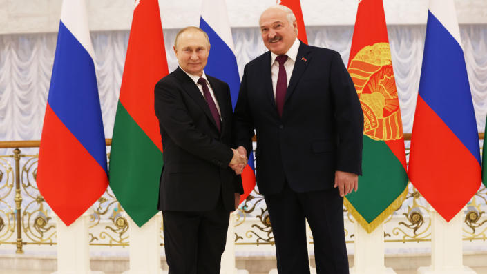 Russian President Vladimir Putin shakes hands with Belarusian President Alexander Lukashenko.