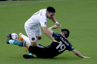 Inter Miami midfielder Lewis Morgan (7) and LA Galaxy defender Jorge Villafana (19) collide during the first half of an MLS soccer match, Sunday, April 18, 2021, in Fort Lauderdale, Fla. (AP Photo/Lynne Sladky)