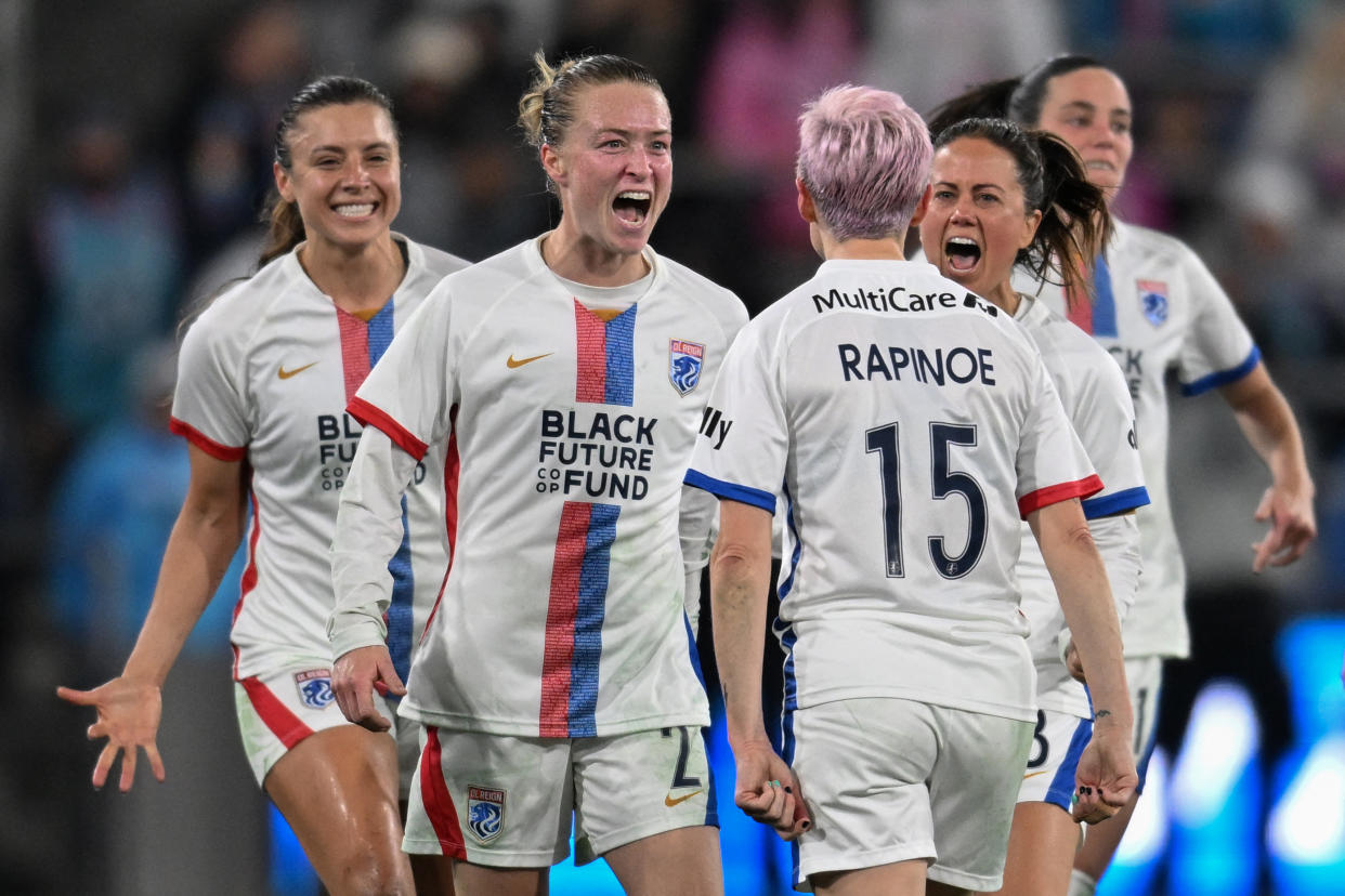 OL Reign's US midfielder #15 Megan Rapinoe celebrates with teammates OL Reign's US midfielder #02 Emily Sonnett and OL Reign's US defender #03 Lauren Barnes after winning the National Women's Soccer League semifinal match against San Diego Wave at Snapdragon Stadium in San Diego, California, on November 5, 2023. (Photo by Robyn Beck / AFP) (Photo by ROBYN BECK/AFP via Getty Images)