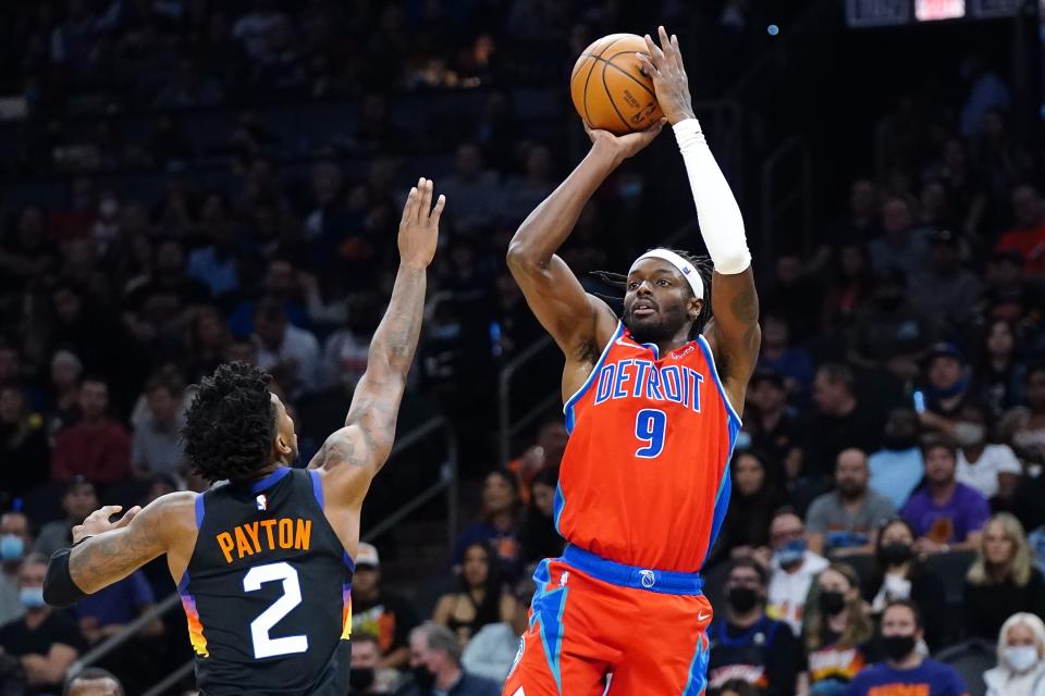 Detroit Pistons forward Jerami Grant (9) shoots over Phoenix Suns guard Elfrid Payton (2) during the first half of an NBA basketball game Thursday, Dec. 2, 2021, in Phoenix. (AP Photo/Ross D. Franklin)