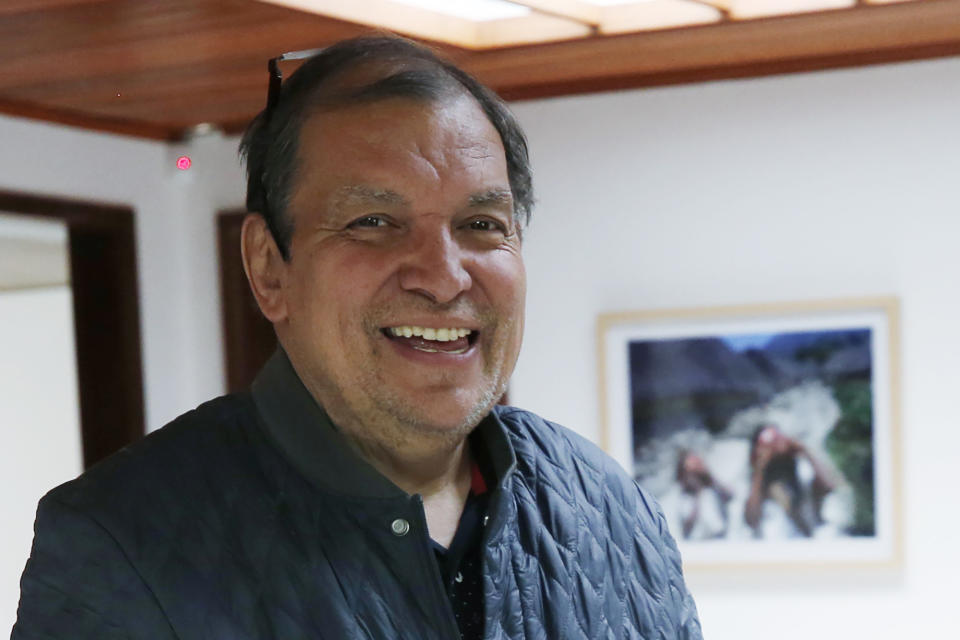 Associated Press reporter Cesar Garcia poses for a photo on his 20 year anniversary with the AP at his office in Bogota, Colombia, Friday, May 31, 2019. Garcia, a veteran reporter who ventured across Colombia to tell the story of the nation's armed conflict, has died at age 61. (AP Photo/Fernando Vergara)