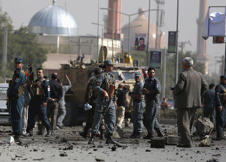 Afghan security personnel keep watch at the site of a suicide car bomb blast in Kabul, Afghanistan October 11, 2015. REUTERS/Ahmad Masood