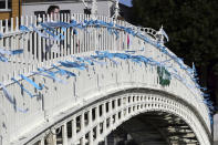 Blue ribbons are tied to Ha'Penny Bridge, Dublin to remember the victims of Catholic Church clerical sex abuse, ahead of the arrival of Pope Francis, in Dublin, Ireland, Saturday, Aug. 25, 2018. The pontiff is traveling to Ireland for a two-day visit on the occasion of the 2018 World Meeting of Families. (Aaron Chown//PA via AP)