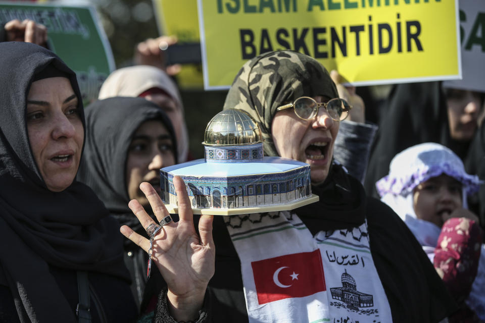 A protester holding a model of the Dome of the Rock mosque, located in east Jerusalem's Old City, chants anti-U.S. slogans during a protest against the proposed U.S. Mideast peace plan following Friday's Muslim prayers outside Fatih mosque in Istanbul, Friday, Jan. 31, 2020. U.S. President Donald Trump's Mideast plan would create a disjointed Palestinian state with a capital on the outskirts of east Jerusalem, beyond the separation barrier built by Israel. The rest of the Jerusalem, including the Old City, would remain Israel's capital. (AP Photo/Emrah Gurel)