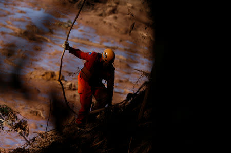 A member of a rescue team searches for victims after a tailings dam owned by Brazilian mining company Vale SA collapsed, in Brumadinho, Brazil January 28, 2019. REUTERS/Adriano Machado