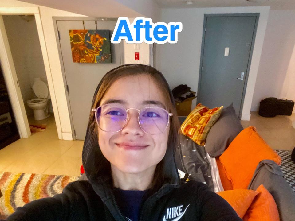 Blue text says "after" at the top of a photo of the author in a basement with a bed behind her.