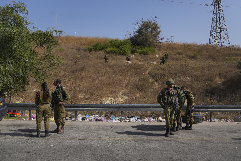 Israeli security forces inspect the scene of a Palestinian ramming attack near West Bank Maccabim checkpoint, Thursday, Aug. 31, 2023. A Palestinian driver slammed his truck into pedestrians at a busy checkpoint in the occupied West Bank on Thursday, killing one Israeli before being shot, Israeli authorities said. (AP Photo/Ohad Zwigenberg)