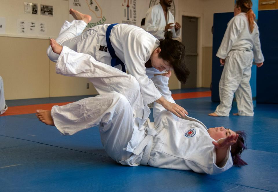 Kimberly Misenhimer, flips Alyx Long during a practice of the Stockton Judo Club at the McKinley Park Community Center in south Stockton.