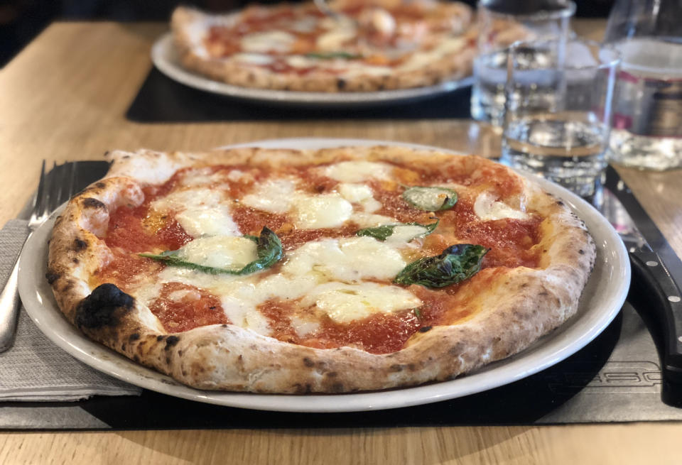 Personal pizzas on a table.