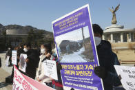 Human rights activists stage a rally calling for better living conditions for migrant workers near the presidential Blue House in Seoul, South Korea on Feb. 9, 2021. Activists and workers say migrant workers in Pocheon work 10 to 15 hours a day, with only two Saturdays off per month. They earn around $1,300-1,600 per month, well below the legal minimum wage their contracts are supposed to ensure. (AP Photo/Ahn Young-joon)