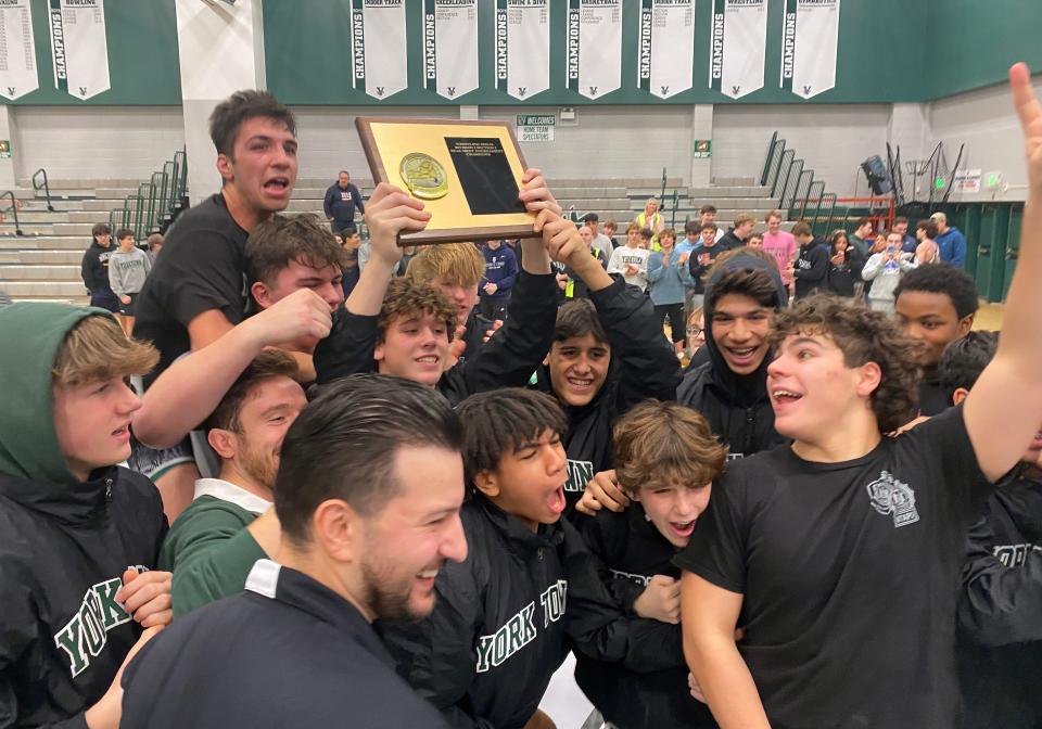 Yorktown wrestlers celebrate their victory over Ossining in the the Section 1 Division I Dual Meet Tournament at Yorktown High School Dec. 21, 2023.