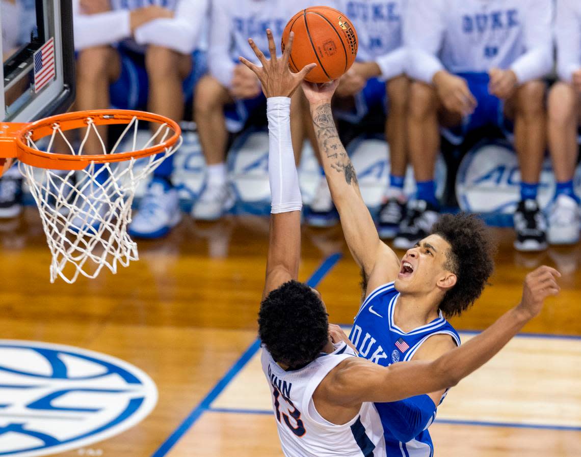 Duke’s Tyrese Proctor (5) drives to the basket against Virginia’s Ryan Dunn (13) in the championship game of the ACC Tournament on Saturday, March 11, 2023 at the Greensboro Coliseum in Greensboro, N.C.