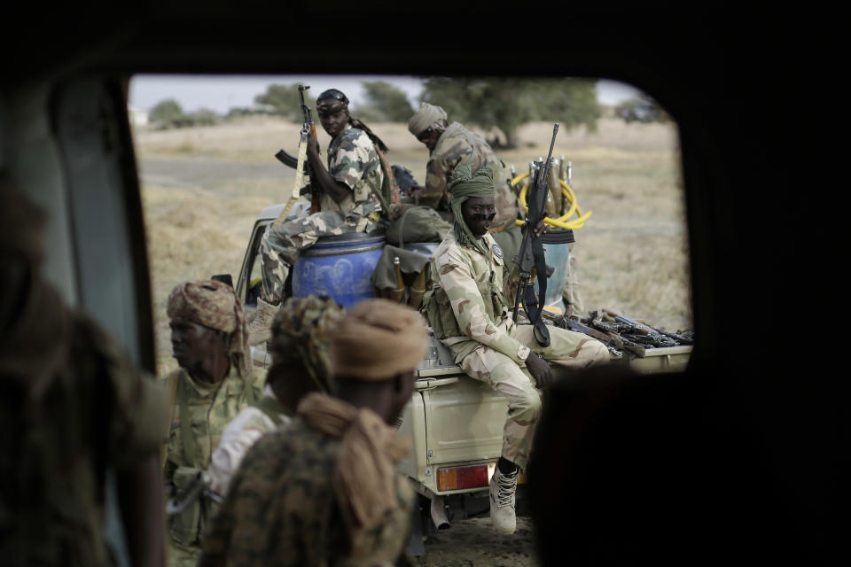 Chadian soldiers transfer weapons seized from Boko Haram fighters to a helicopter in the Nigerian city of Damasak, Nigeria, Wednesday March 18, 2015. (AP Photo/Jerome Delay)
