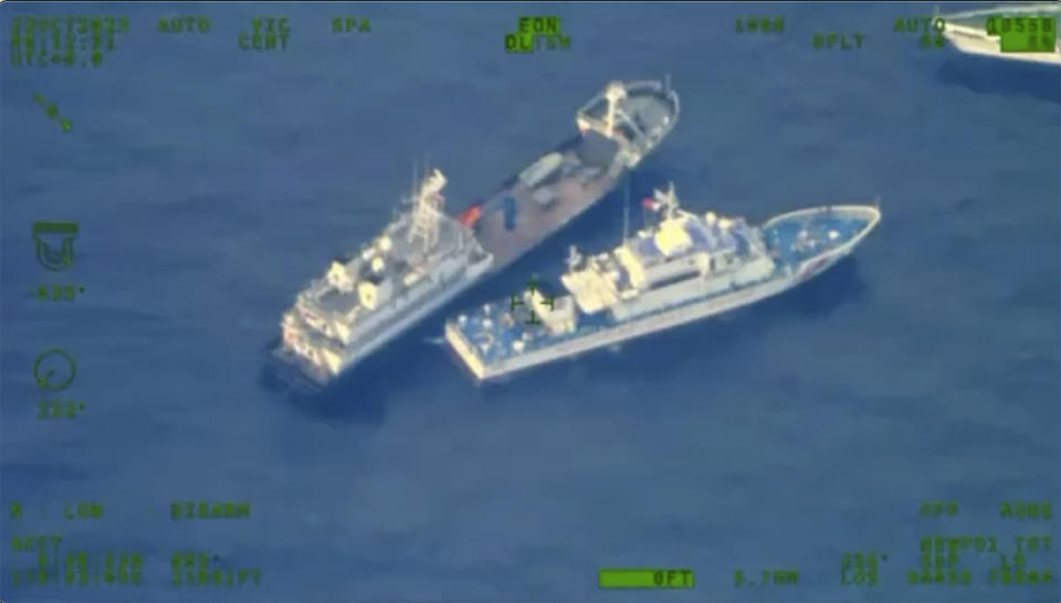 This image released by the Armed Forces of the Philippines, shows a Chinese militia vessel, top, near Philippine coast guard vessel BRP Cabra as they approach Second Thomas Shoal, locally called Ayungin Shoal, at the disputed South China Sea on Sunday Oct. 22, 2023. (Armed Forces of the Philippines via AP)