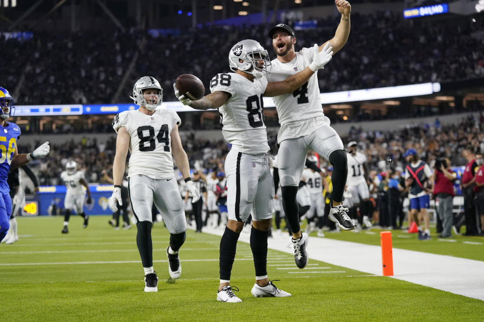 Las Vegas Raiders wide receiver Marcell Ateman (88) celebrates his touchdown catch with quarterback Derek Carr, right, next to tight end Matt Bushman (84) during the second half of a preseason NFL football game against the Los Angeles Rams on Saturday, Aug. 21, 2021, in Inglewood, Calif. (AP Photo/Ashley Landis)