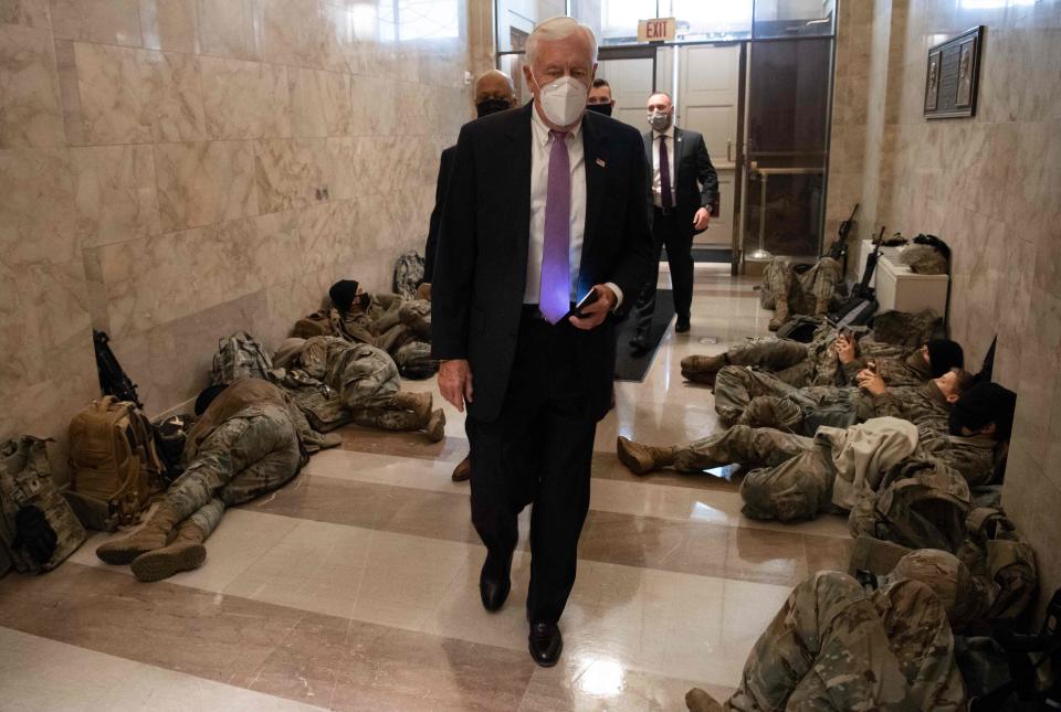 House Majority Leader Steny Hoyer, D-Md., walks past members of the National Guard as he arrives at the US Capitol in Washington, D.C., on Wednesday, when the House plans to vote to impeach President Donald Trump a second time.