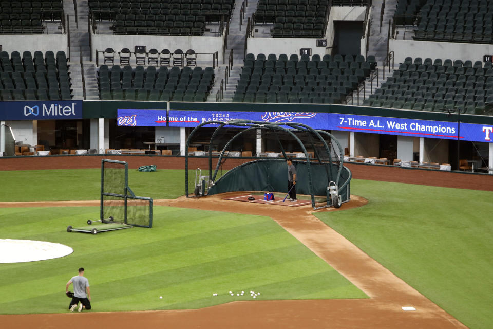 Unidentified players workout at Globe Life Field, home of the Texas Rangers baseball team, in Arlington, Texas, Monday, June 1, 2020. The coronavirus pandemic has forced universities, leagues and franchises to evaluate how they might someday welcome back fans. At baseball games in Taiwan, up to 1,000 spectators have been allowed into the ballpark, but they are barred from bringing in food, concession stands are closed and they are told to sit three seats apart. (AP Photo/LM Otero)