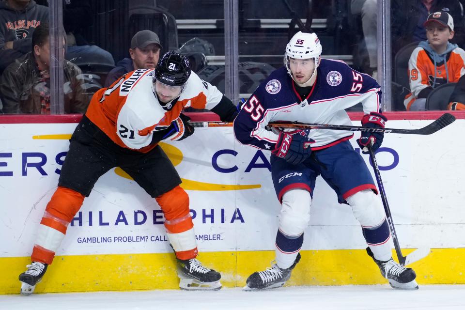 Philadelphia Flyers' Scott Laughton, left, tries to get away from Columbus Blue Jackets' David Jiricek during the second period of an NHL hockey game, Sunday, Nov. 19, 2023, in Philadelphia. (AP Photo/Matt Slocum)