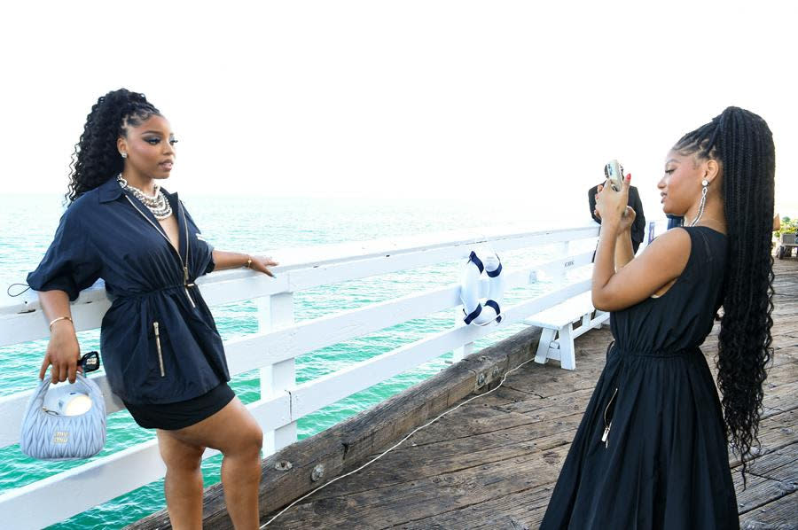 (Left to Right) Sisters Chloe Bailey and Halle Bailey enjoy the view at the Miu Miu Summer Club Malibu on the Malibu Pier in Malibu. (Jon Kopaloff/Getty Images for Miu Miu)