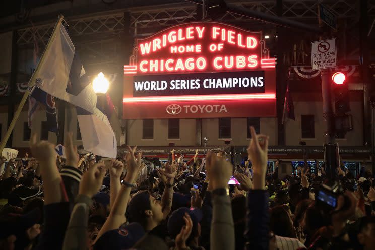 CHICAGO, IL - NOVEMBER 02: Chicago Cubs fans celebrate outside Wrigley Field after the Cubs defeated the Cleveland Indians in game seven of the 2016 World Series on November 2, 2016 in Chicago, Illinois. The Cubs 8-7 victory landed them their first World Series title since 1908. (Photo by Scott Olson/Getty Images)