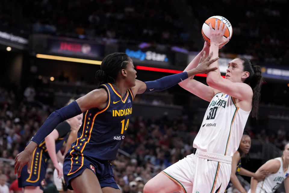New York Liberty forward Breanna Stewart (30) shoots over Indiana Fever center Temi Fagbenle (14) in the first half of a WNBA basketball game, Thursday, May 16, 2024, in Indianapolis. (AP Photo/Michael Conroy)