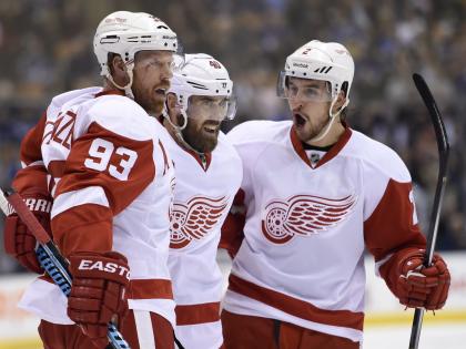 Frp, left to right, Detroit Red Wings&#39; Johan Franzen, Henrik Zetterberg and Brendan Smith celebrate Franzen&#39;s goal against the Toronto Maple Leafs during first-period NHL hockey game action in Toronto, Friday, Oct. 17, 2014. (AP Photo/The Canadian Press, Frank Gunn)