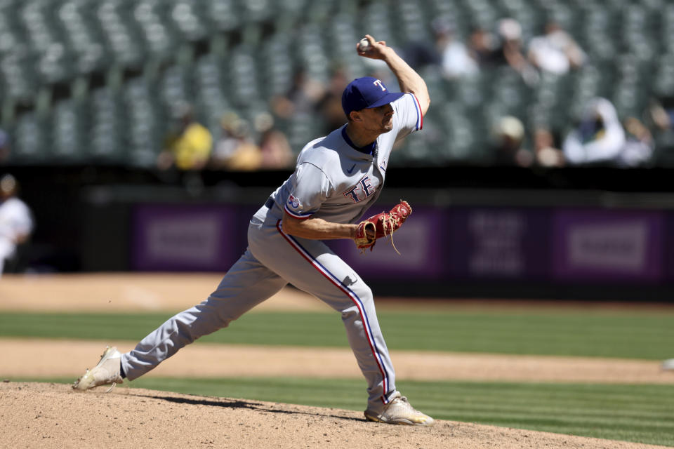 Texas Rangers' Brock Burke throws against the Oakland Athletics during the sixth inning of a baseball game in Oakland, Calif., Sunday, May 29, 2022. (AP Photo/Jed Jacobsohn)