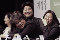 Bong Joon-ho, director of Oscar-winning “Parasite,” second from right, the Oscar-winning film "Parasite", listens to a question during a press conference in Seoul, South Korea, Wednesday, Feb. 19, 2020. Bong said Wednesday “the biggest pleasure and the most significant meaning” that the film has brought to him was its success in many countries though the audiences might feel uncomfortable with his explicit description of a bitter wealth disparity in modern society. (AP Photo/Ahn Young-joon)