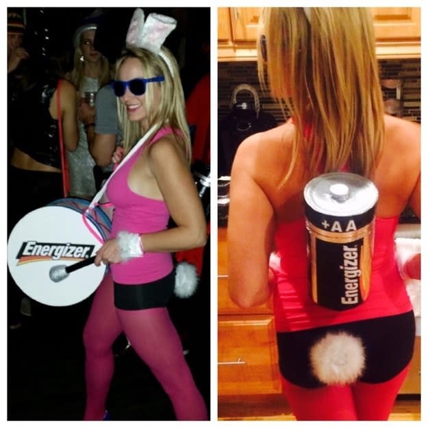 Someone holding a fake drum with a fake battery attached to their back, with bunny ears