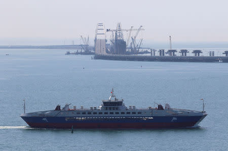 A view from Mount Mithridat shows a bridge, which was constructed to connect the Russian mainland with the Crimean Peninsula across the Kerch Strait, with a Pobeda ferry seen in the foreground, Crimea May 16, 2018. REUTERS/Pavel Rebrov