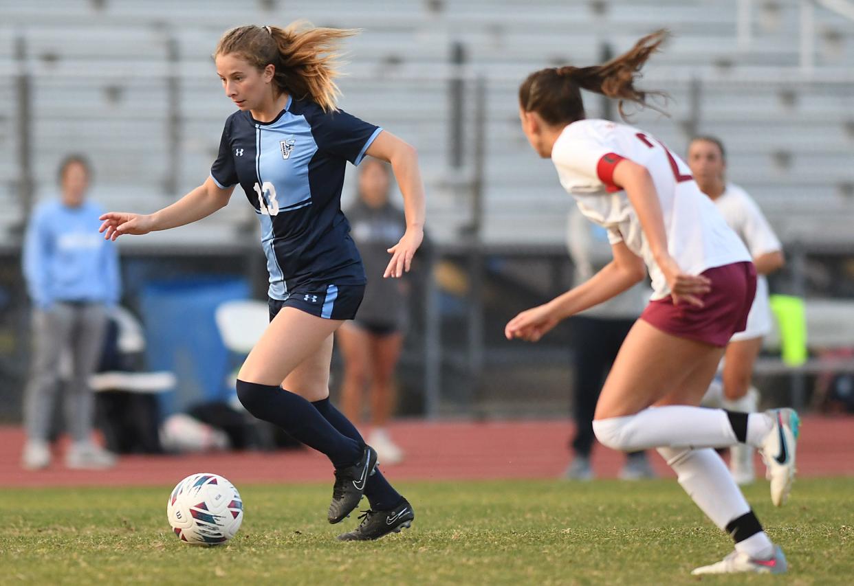 Hoggard's #13 Ellis Kelly drives down the field as Hoggard took on Ashley Tuesday March 26, 2024 at Scott Braswell Stadium in Wilmington, N.C. Ashley won 3-1. KEN BLEVINS/STARNEWS