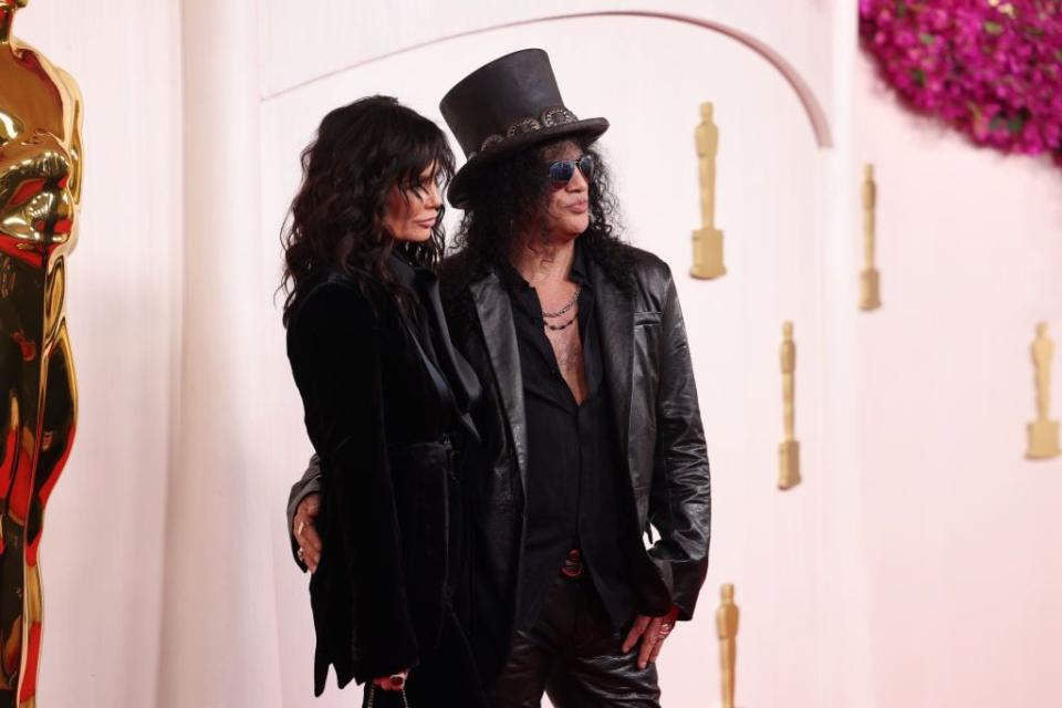 Meegan Hodges and Slash Kristen arrive for the Academy Awards.