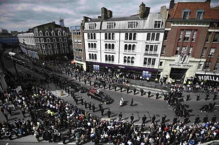 Police officers line the street as the coffin of PC Keith Palmer, who was killed in the recent Westminster attack, is transported from the Palace of Westminster, where it laid overnight, to his funeral at Southwark Cathedral in central London, Britain April 10, 2017. REUTERS/Hannah McKay