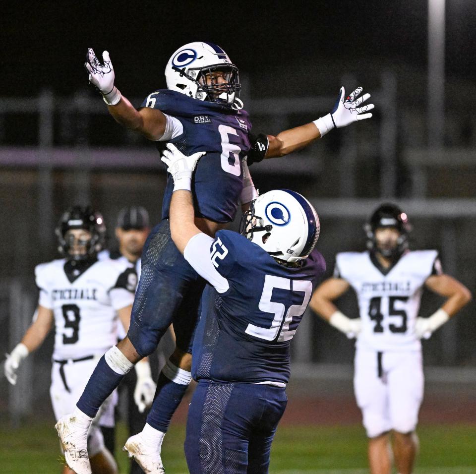 Central Valley Christian's Tyler Hughes hoists Bryson Donelson after a touchdown against Stockdale in a Central Section Division II high school football playoff on Friday, November 3, 2023.