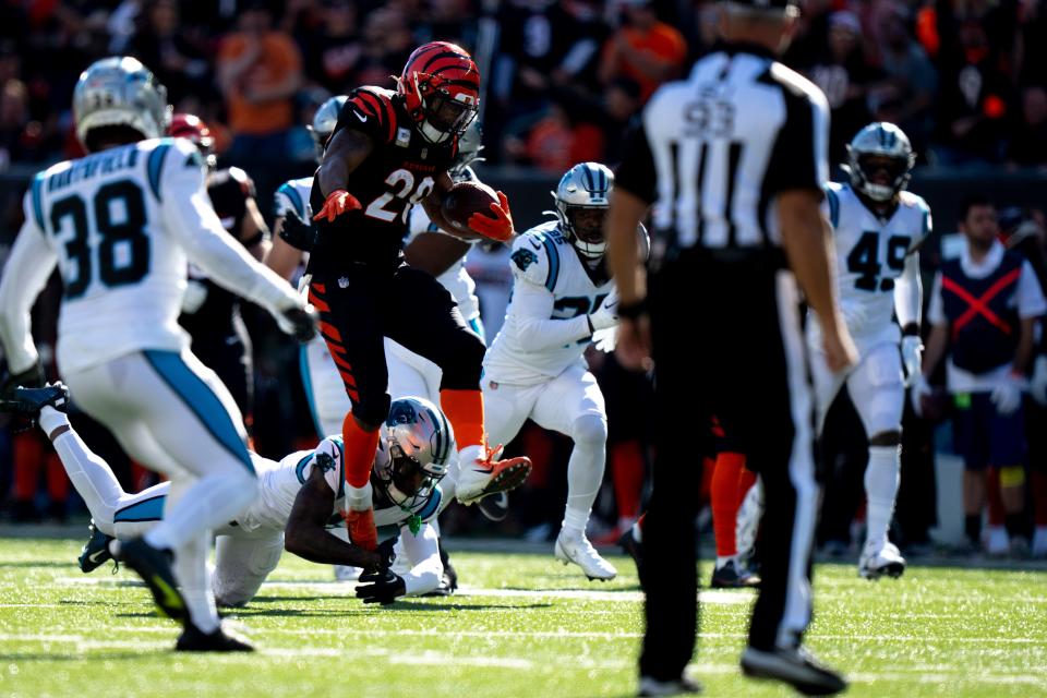 Cincinnati Bengals running back Joe Mixon (28) slips a tackle attempt by Carolina Panthers cornerback Jaycee Horn (8) in the first quarter during a Week 9 NFL game, Sunday, Nov. 6, 2022, at Paycor Stadium in Cincinnati. Mandatory Credit: Albert Cesare-The Enquirer