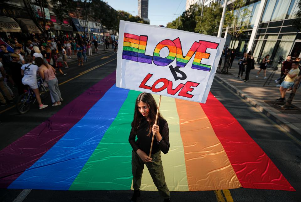 A participant holds a banner before the annual gay pride march in Belgrade, Serbia, Sunday, Sept. 15, 2019.