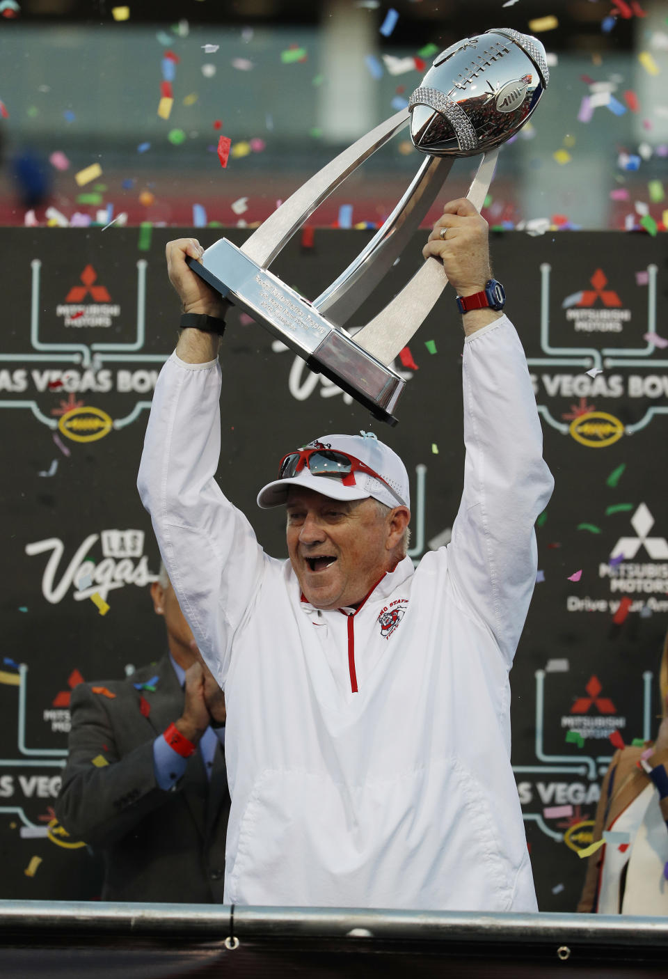 Fresno State head coach Jeff Tedford holds up the trophy after his team defeated Arizona State in the Las Vegas Bowl NCAA college football game, Saturday, Dec. 15, 2018, in Las Vegas. (AP Photo/John Locher)