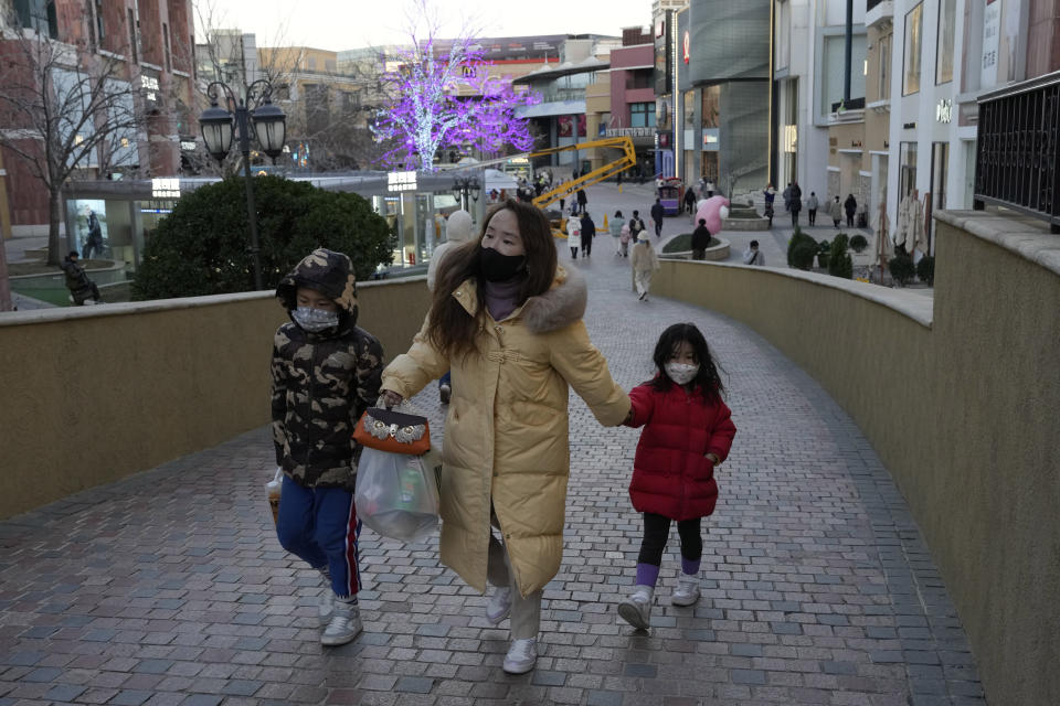 Shoppers return to a mall with shops re-opening for business as restrictions are eased in Beijing, Saturday, Dec. 3, 2022. Chinese authorities on Saturday announced a further easing of COVID-19 curbs with major cities such as Shenzhen and Beijing no longer requiring negative tests to take public transport. (AP Photo/Ng Han Guan)