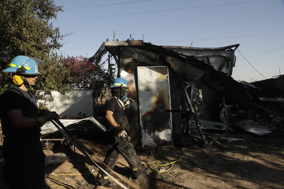 Israeli firefighters arrive at kibbutz in south Israel hit by rocket fire from Gaza that killed two Thai workers inside a packaging plant in southern Israel , Tuesday, May 18, 2021. Since the fighting began last week, the Israeli military has launched hundreds of airstrikes it says are targeting Hamas' militant infrastructure, while Palestinian militants have fired thousands of rockets into Israel. (AP Photo/Maya Alleruzzo)