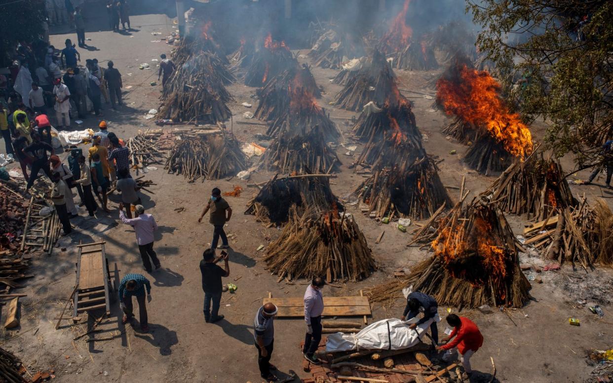 Funeral pyres burn at a makeshift crematorium in New Delhi - AP Photo/Altaf Qadri