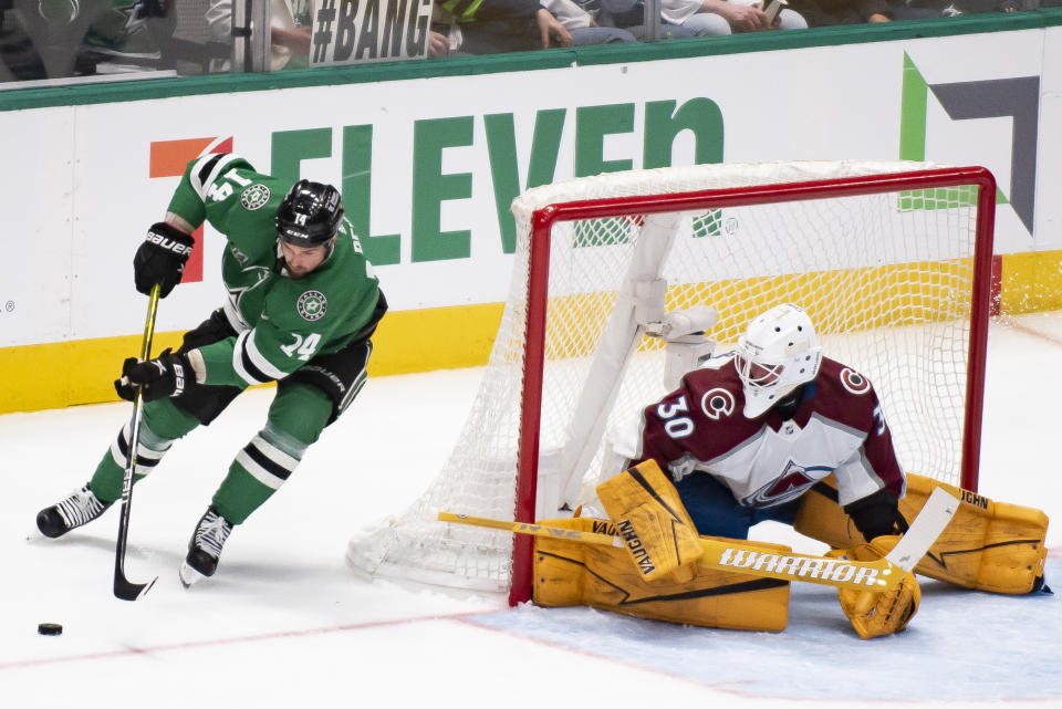 Dallas Stars left wing Jamie Benn (14) skates around the goal as Colorado Avalanche goaltender Keith Kinkaid (30) defends during an NHL hockey game, Saturday, March 4, 2023, in Dallas. (AP Photo/Emil T. Lippe)