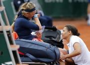 Tennis - French Open - Roland Garros - Karin Knapp of Italy vs Victoria Azarenka of Belarus - Paris, France - 24/05/16. Victoria Azarenka reacts as she gets medical help. REUTERS/Pascal Rossignol