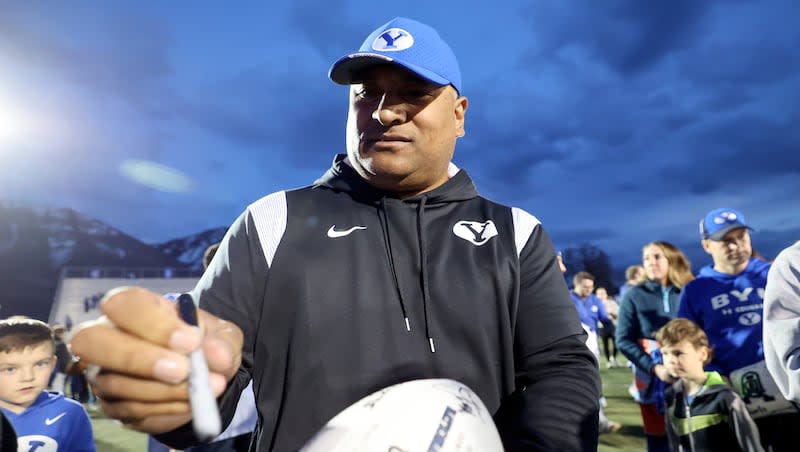 BYU football coach Kalani Sitake signs an autograph after the BYU alumni game at BYU in Provo on Friday, March 22, 2024. Sitake and the Cougars wrapped up spring camp last week having learned some things but not everything.