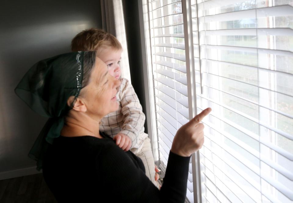 Having come from Ukraine, Tamara Holod shows her grandson, Lucas Shobei, the Amish horse and buggy he'd just heard out the window of their rented house in Goshen on Nov. 10, 2023.