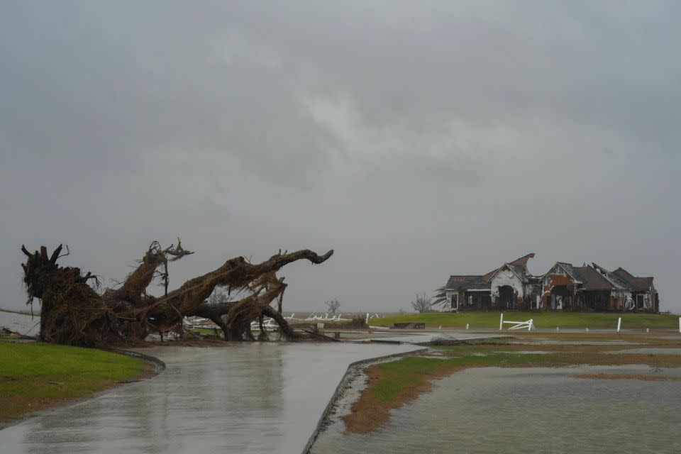 A fallen tree and a house which were damaged by Hurricane Laura are seen as Hurricane Delta approaches on October 9 in Cameron, Louisiana.