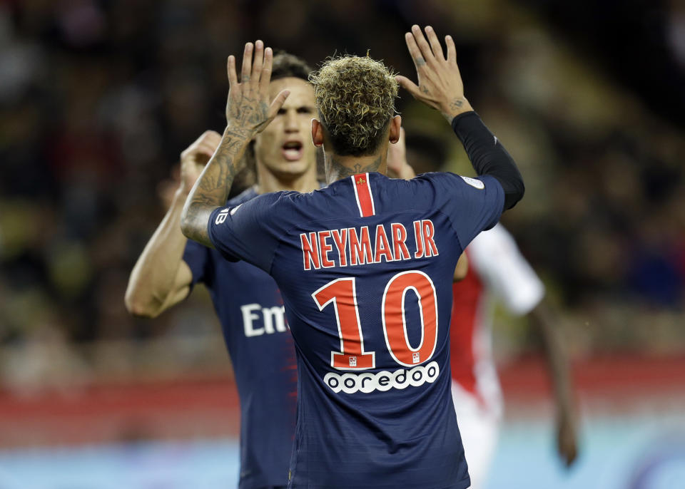 PSG's Neymar celebrates with teammate Edinson Cavani after scoring his side's forth goal during the French League One soccer match between AS Monaco and Paris Saint-Germain at Stade Louis II in Monaco, Sunday, Nov. 11, 2018 (AP Photo/Claude Paris)