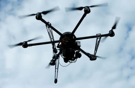 A drone is used to survey high-voltage power lines of electric company Westnetz near Wilnsdorf, Germany, July 11, 2018. REUTERS/Ralph Orlowski