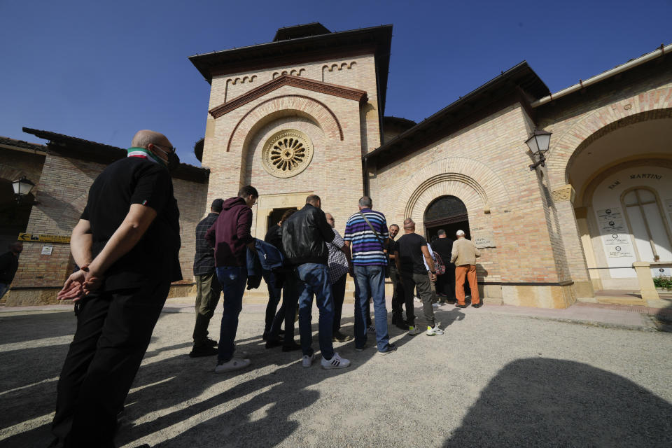 People queue to visit the tomb of Fascist Dictator Benito Mussolini on the occasion of the 100th anniversary of the march on Rome, in Predappio, Italy, Friday, Oct. 28, 2022. (AP Photo/Luca Bruno)