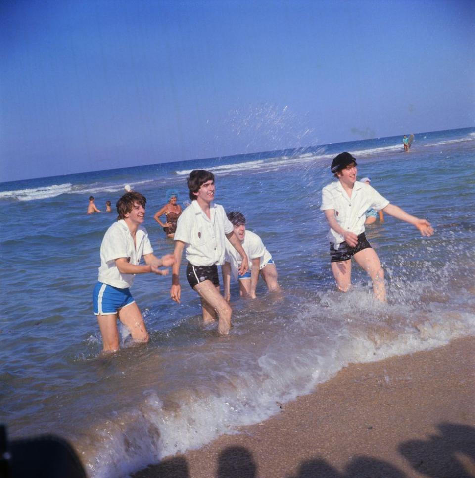 <p>The Beatles splash onlookers at Miami Beach, Florida, in 1964. </p>